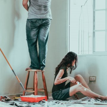two people painting a room in their house 